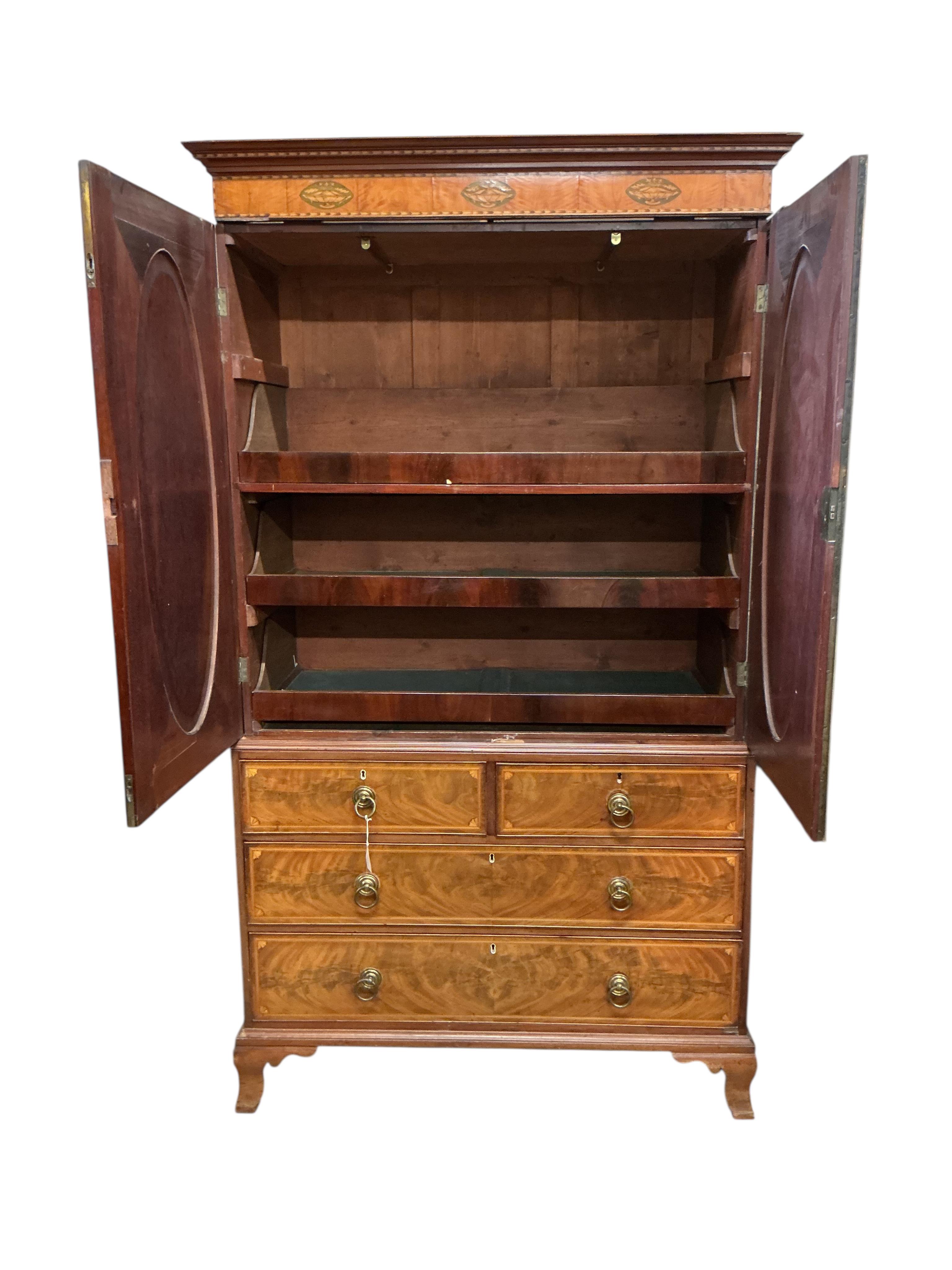 A George IV marquetry inlaid mahogany linen press, width 124cm, depth 60cm, height 223cm